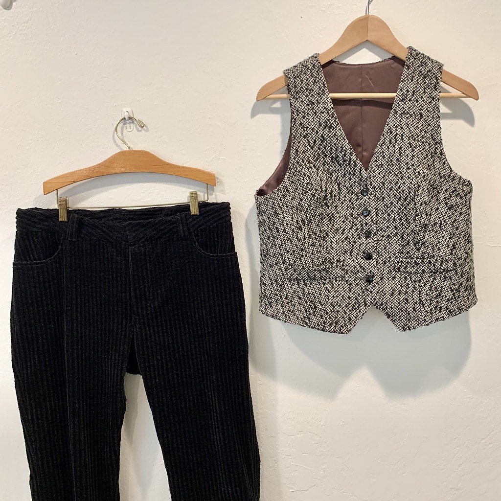 Black tweed vest and jeans on hangers