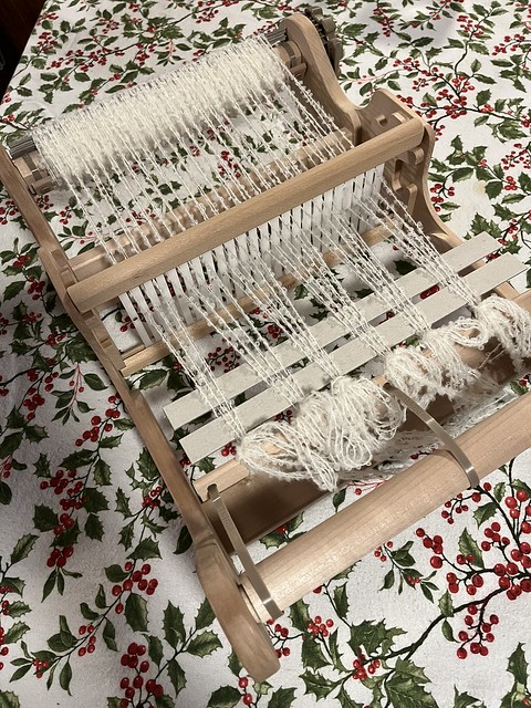 I still haven’t put away my Christmas tablecloth but here I have warped the Ashford Sampleit looms that we use for classes with the boucle we will use for the upcoming class. Sign up to make your own beautiful scarf!