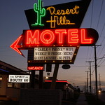 Desert Hills Motel neon sign - Tulsa, OK My Wife and I stayed at this vintage Route 66 Motel on our road trip last summer.

The pros of staying here:

This fantastic vintage sign.

The Motel has retained some vintage features of a high end motel from back in the day - the walls facing the parking lot are zig-zagged or accordion-style for a memorable look. The bathroom had heated floors, which was very nice.

The room itself was practically a museum - our room had a vintage black-and-white TV, a rotary telephone and typewriter.  

There were also modern amenities like a modern flat screen TV and a mini-fridge of retro design.

The owner was nice. I asked if he sold post cards and he gave me one for free.

the con of staying here:

It&#039;s in a questionable neighborhood, and priced cheaper than the dependable chain motels. Thus the clientele was a mix of tourists and riff raff. The young couple in the next room drove a 60&#039;s station wagon, but there was a guy across the way who was yelling and cussing at me while I took this sign.  Despite that, I&#039;m glad I stayed here.