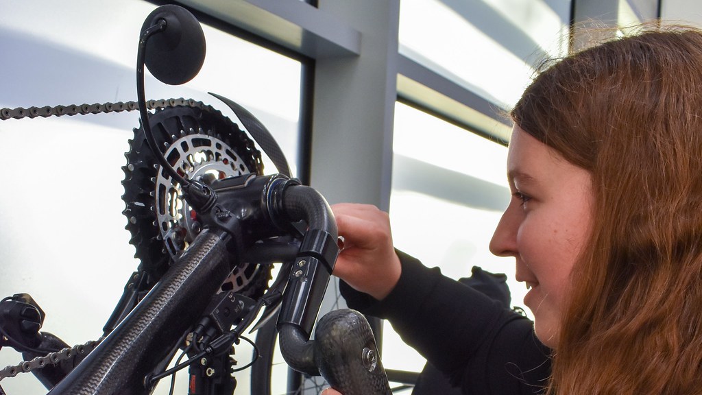 Close up of Hannah inspecting a bicycle prototype