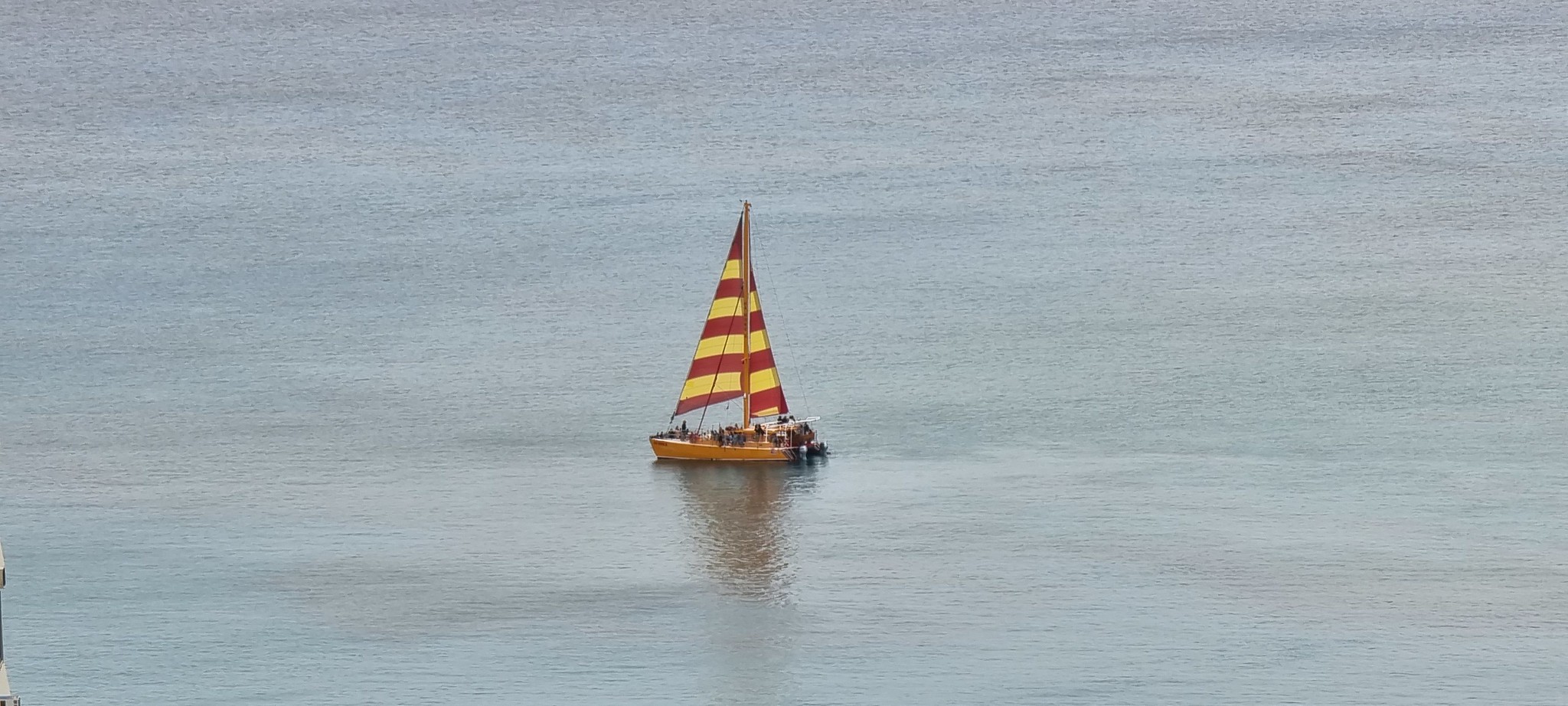 A colourful yacht viewed from room 3304 of the Hilton Waikiki Beach