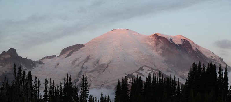 Dawn's first light striking Mount Rainier from the Sunrise Visitor Center parking lot