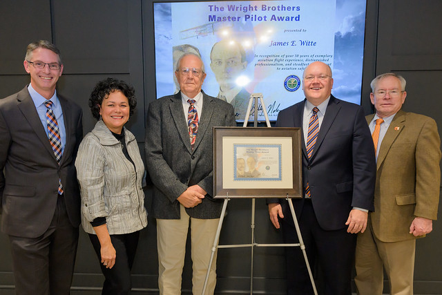 Auburn School of Aviation Director James Witte, center, with, from left to right, Jason Hicks, wife, Maria Witte, Christopher B. Roberts and Ronald Burgess.