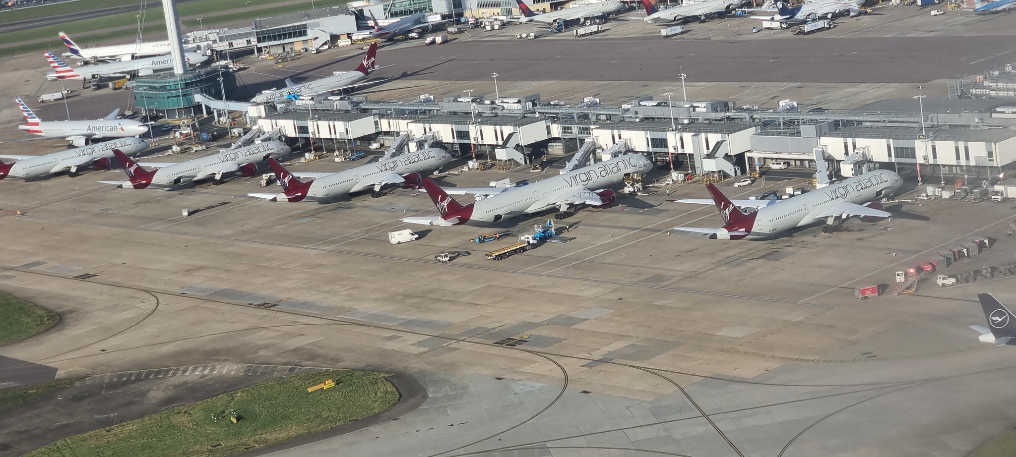 A collection of Virgin aircraft at gates at Heathrow