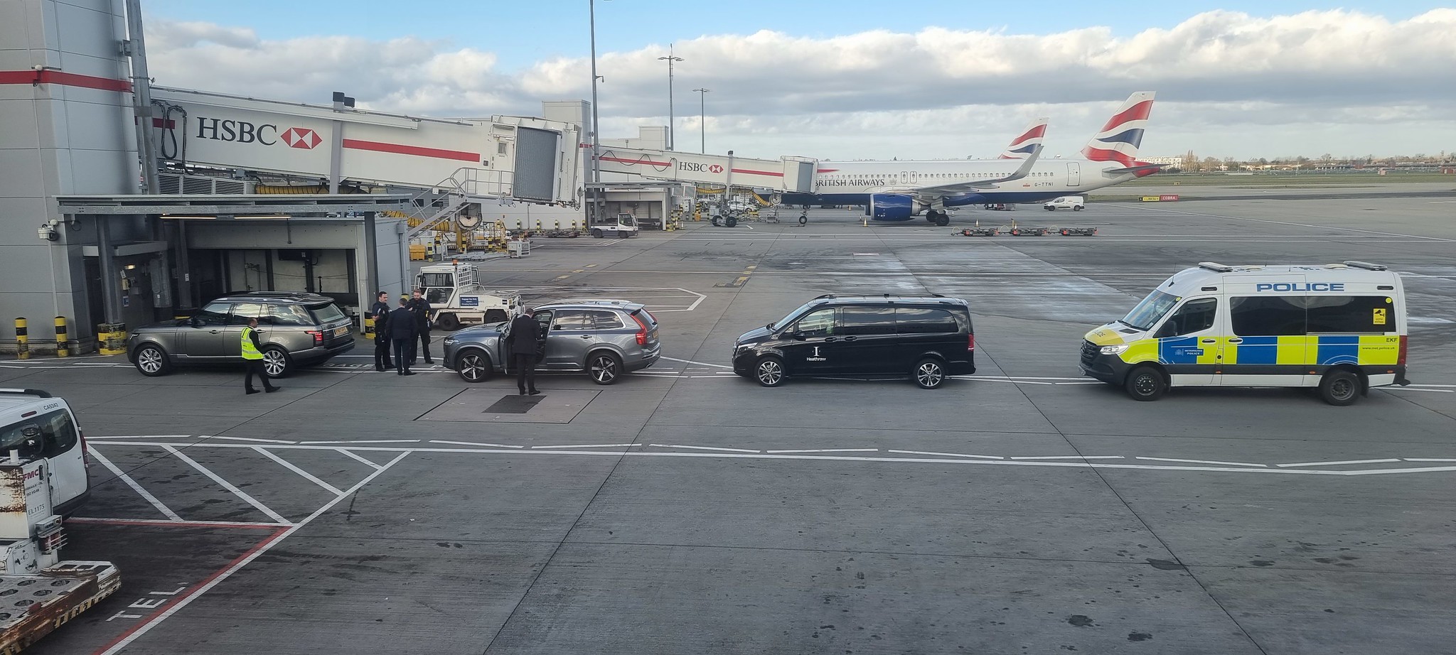 The convoy of vehicles awaiting arrival of a celeb at Gate A8 at Heathrow T5