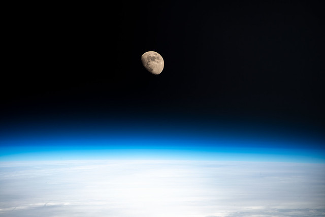 The waxing gibbous Moon above Earth's horizon