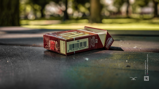 Open pack of L&M cigarettes on the table in a city park, Portland, Oregon, 7-2022 (Vlad Meytin, vladsm.com)