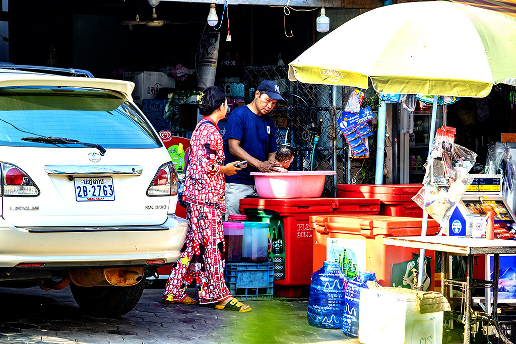 Man washing his baby son in a tub on 2-2-23--Siem Reap copy