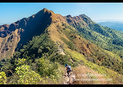 Hiker heading to the knife-edge ridge on Khao Chang Phueak, Thong Pha Phum National Park, Kanchanaburi, Thailand