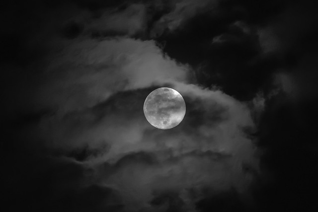 Full moon behind the night clouds ...