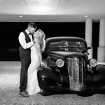 Bride and groom with classic car at night 