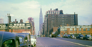 Hey mac, get me to Brooklyn and step on it!! West 34th Street looking east toward Midtown, the New Yorker Hotel and the Empire State Building.  Based on the cars, this is from around 1950.