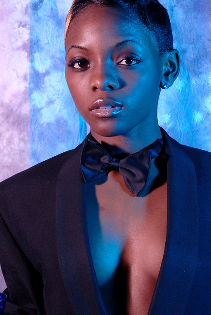 DSC_0581v Sindi Southern Africa Fashion Model in Black Dinner Jacket and Bow Tie with Glass of Champagne Blue and Mauve Lighting Portrait Photoshoot Shoreditch Studio London