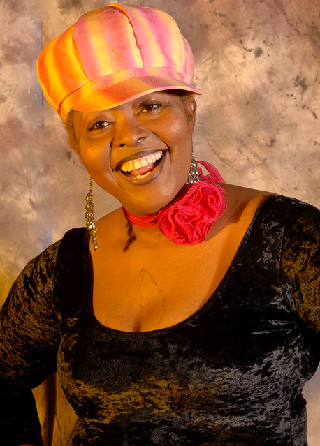 DSC_0206v Ammy Togolese Singer in Black Top and Pink and Yellow Hat with Red Rose Neckband Portrait Photoshoot Shoreditch Studio London