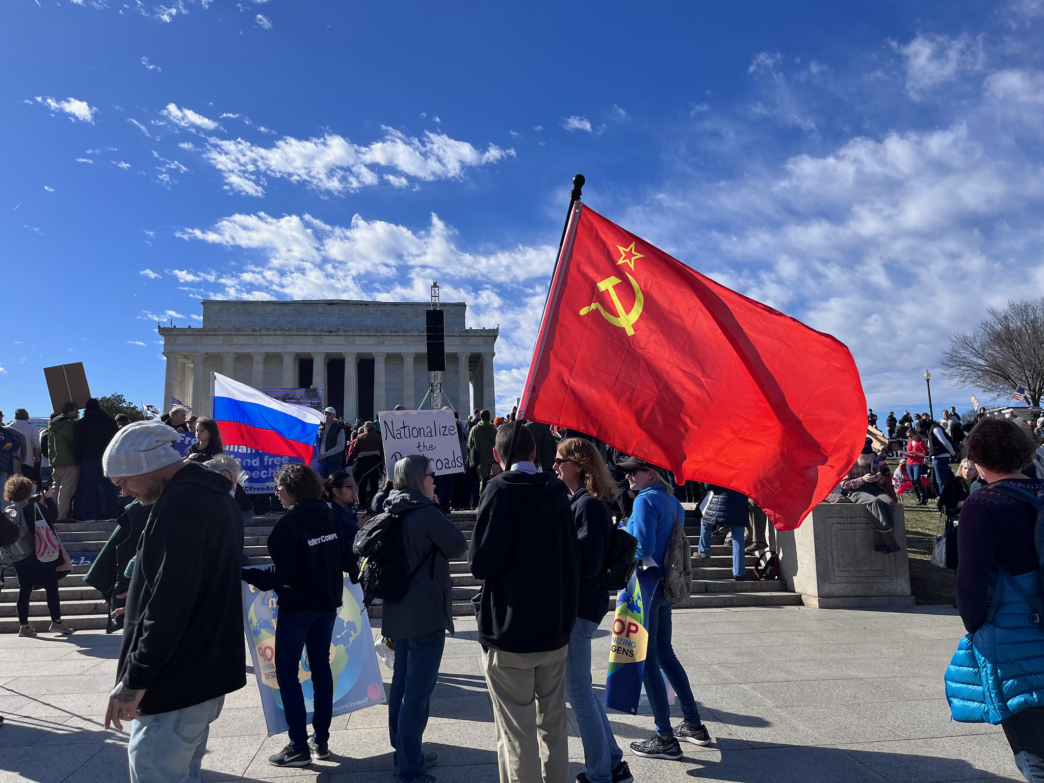 Soviet and Russian flags at Rage Against the War Machine rally