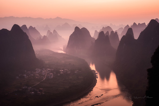 Mountain landscape in the mist at dawn with Li river in Xinping