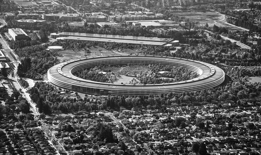 A serene aerial shot of the iconic spaceship-shaped Apple Park