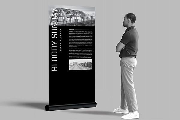 A man looks at a Selma Bloody Sunday display kiosk