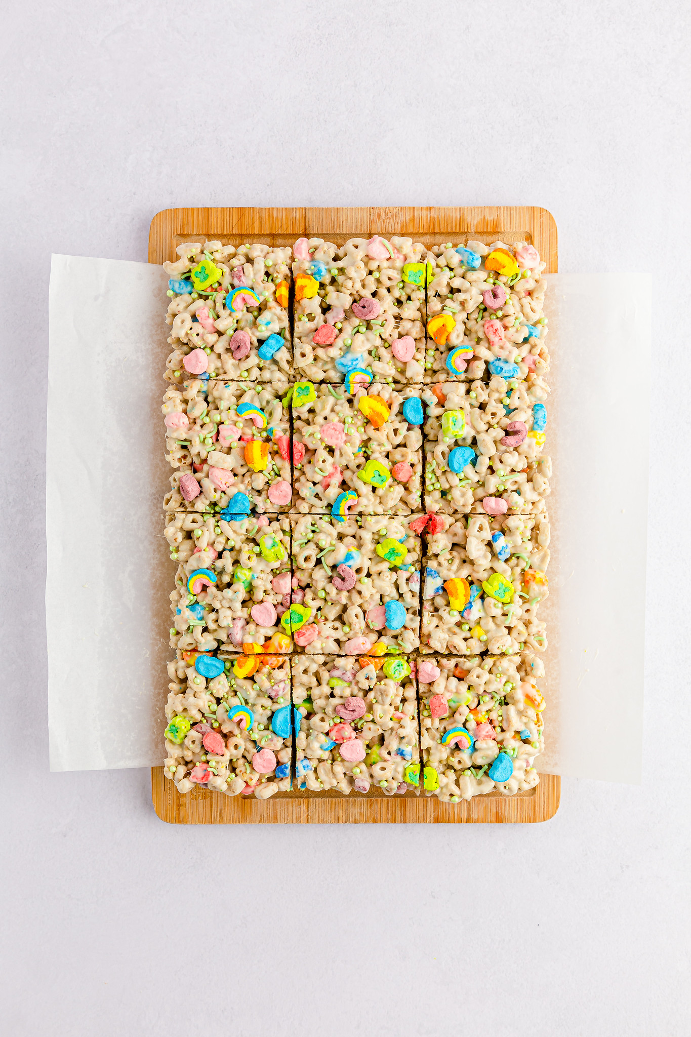12 lucky charms treats on a wooden cutting board and parchment paper