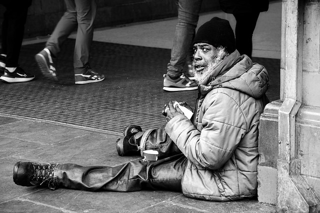 Man begging outside Earls Court Tube Station, London