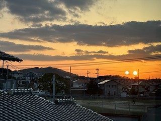 Twin suns setting over Itoshima, Japan