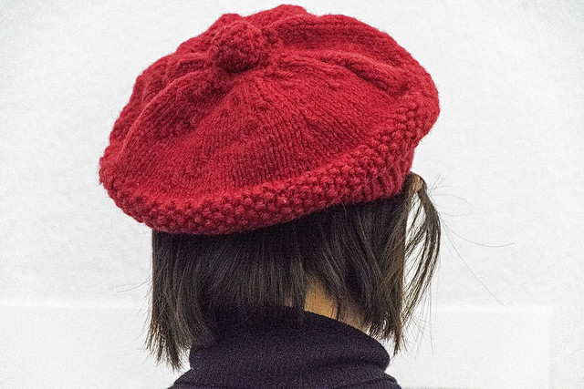 Woman wearing a knitted, red beret