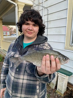 Photo of young man holding a fish