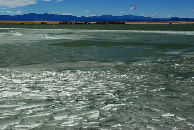 Lake Springer covered with ice. Sangre de Christo Mountains on the horizon. Colfax Co., New Mexico, USA.