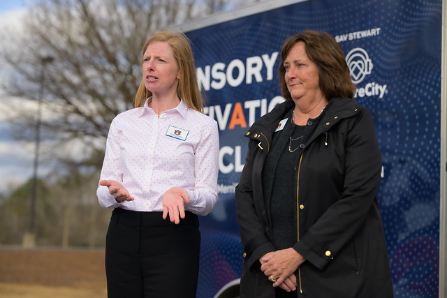 Morgan Yordy and Ann Lambert stand in front of the Sensory Activation Vehicle.
