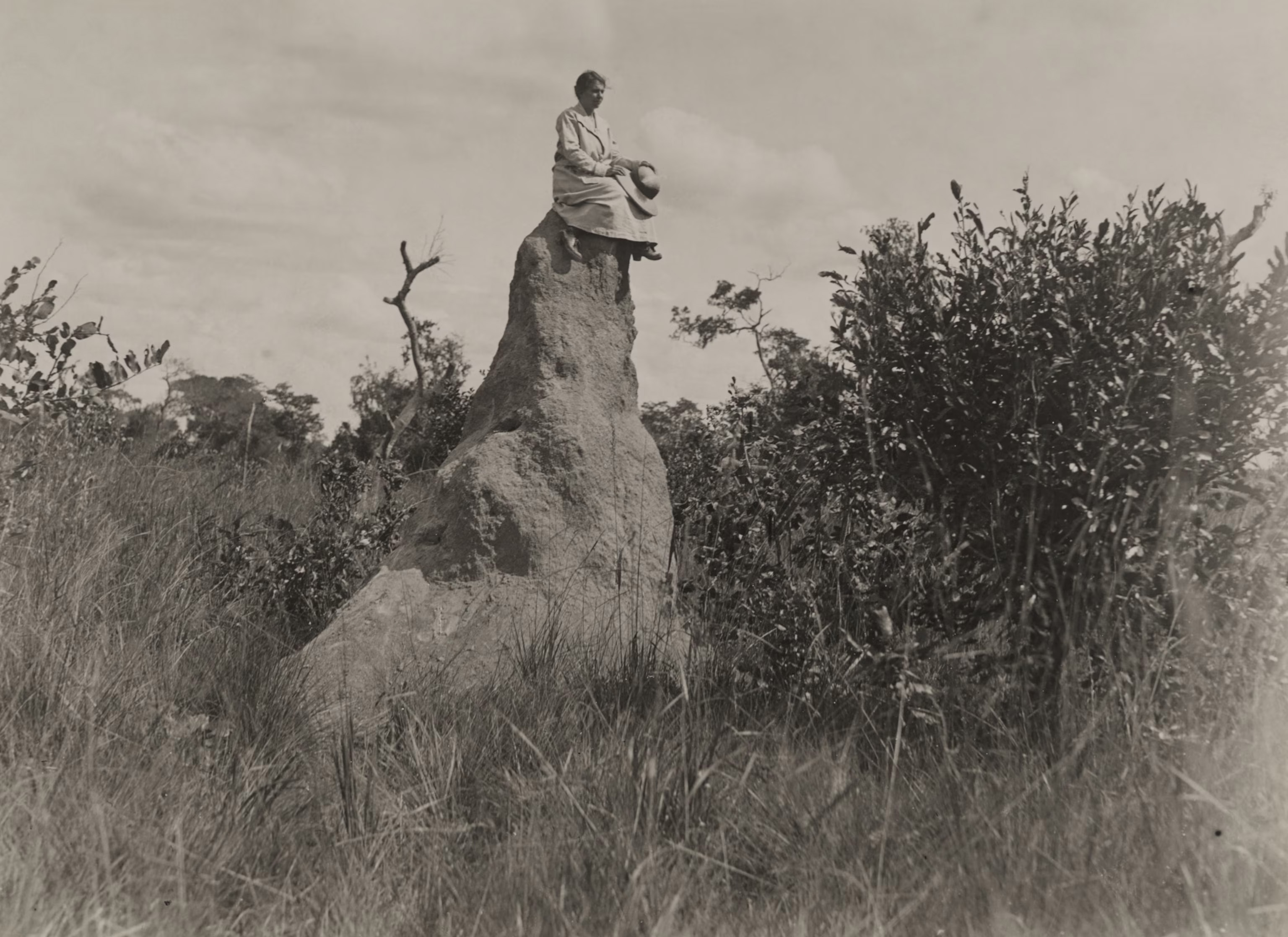 Frank J. Magee :: A woman sits on top of a large white anthill near Elizabethville (Belgian Congo), before 10-1922. | Nat Geo