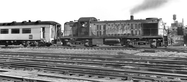 New Haven Railroad ALCO RS-2 road switcher 0503 is moving a Pullman-Standard lightweight 6 wheel truck stainless steel dining car in the yard at Boston, Massachusetts, 1960