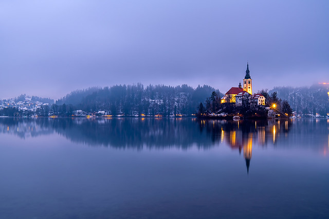 Lake of bled at sunset in winter with fog