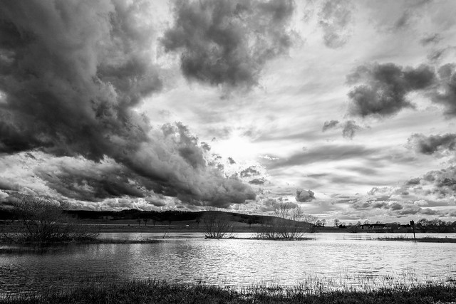 Rain clouds over a flooded river