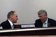 Rep. Pat Callahan talks with Rep. Piscopo at a legislative hearing