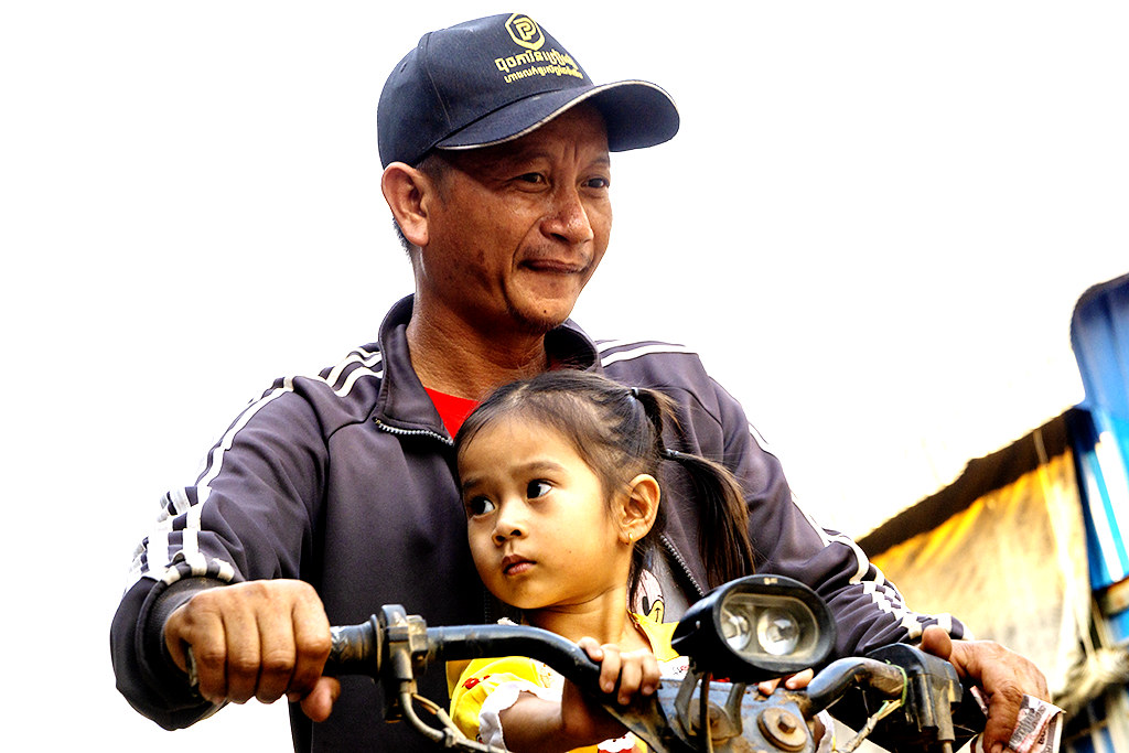 Man and small daughter on beatup motorbike on 3-16-23--Stung Treng copy