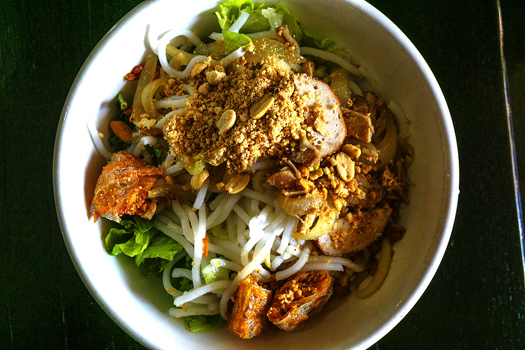 $1 bowl of rice noodles with pork roll, bits of pork and fried spring roll on 3-16-23--Stung Treng copy