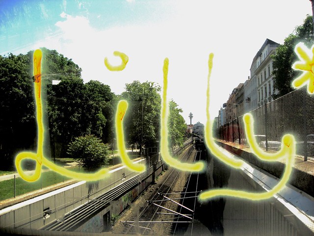 Lilly Suspended in mid-air urban spray graffiti in Vienna on Glass across a railway - urban photography Wien, Österreich, Europa