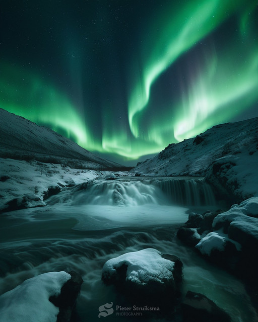 Northern light above a norwegian waterfall