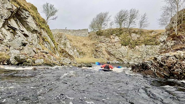 Hannah descending the Cemetery rapid of  Dirlot Gorge, Thurso River. Photo by Colin Mathieson.