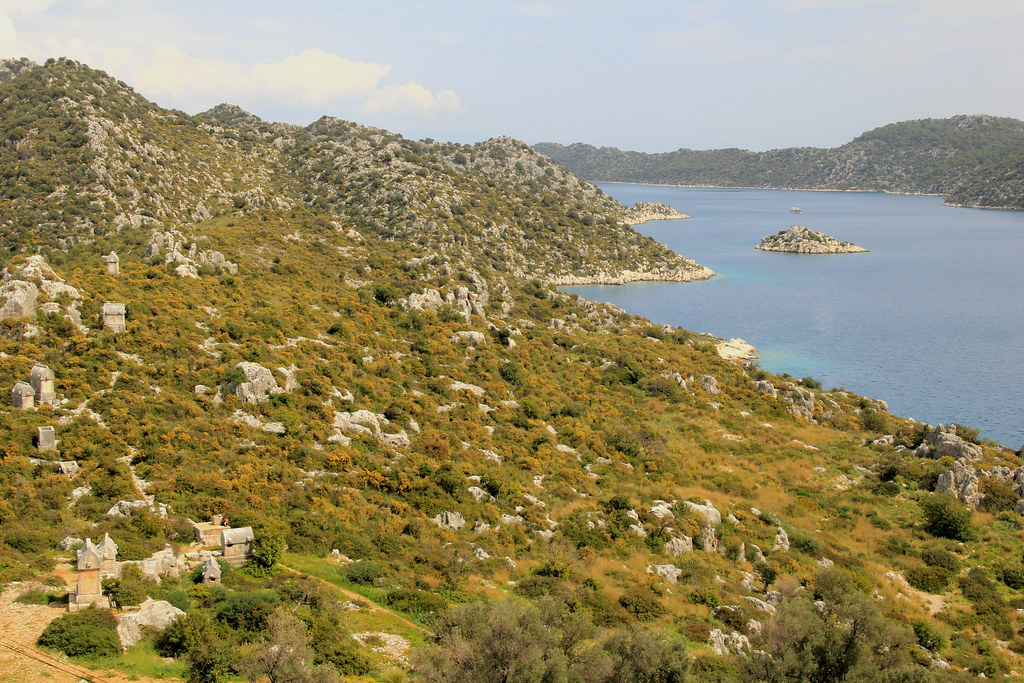 Views from Simena Castle of Lycian tombs dotted across the hillside.