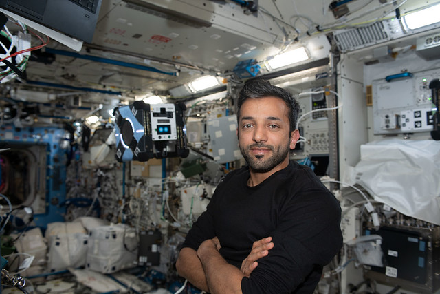 UAE astronaut Sultan Alneyadi poses with a free-flying AstroBee