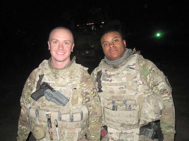Greg Johnson stands next to another soldier.