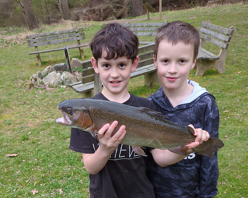 Christian Fritz caught this large rainbow trout and hams it up with his brother Everett for the camera held by a proud father. Photo by Craig Fritz