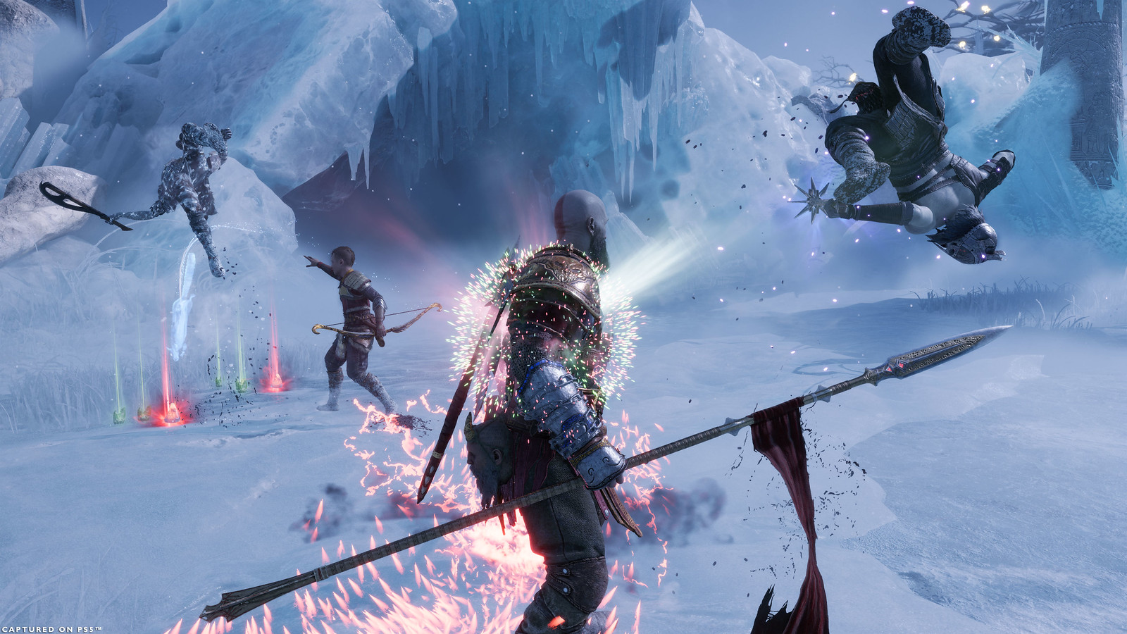 Kratos and Atreus fight against a pair of Draugr in the Niflheim Arena. Kratos is mid-stepping on a Health Crystal, the effects of Health and Rage gain envelop his chest. The Draugr closest to Kratos is being pushed away from the explosion caused by using the crystal. Atreus is using his Runic Summon Bitter Squirrel, which is dropping both Health and Rage Stones onto the arena floor. 