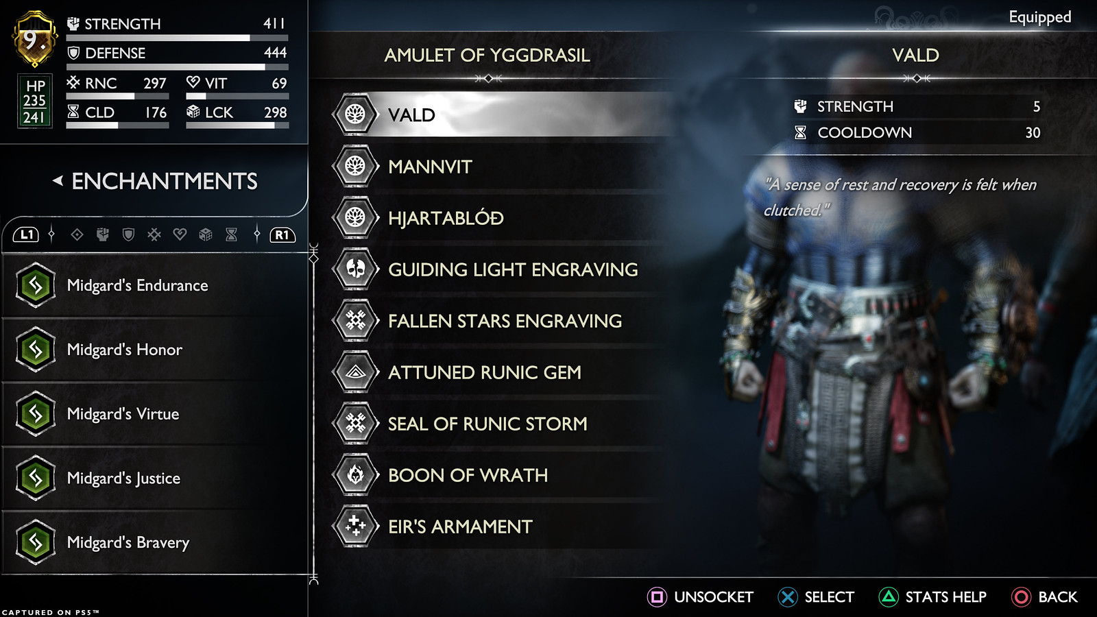 Image show the in-game Enchantments menu with the recommended Enchantments equipped in the Amulet of Yggdrasil. The selected Enchantment Vald, which greatly raises Kratos’ Cooldown stat. This Enchantment is exclusive to NG+ and drops after defeating a Berserker Soul.  