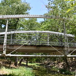 Bulman Bridge – Pecan Creek Park (Hamilton County, Texas) Historic Bulman Bridge in Pecan Creek Park in Hamilton County, Texas.  The bridge is a bowstring pony truss and was built by the King Bridge Company of Cleveland, Ohio in 1884.  It was originally located on CR-301 over Leon Creek.  It was relocated to Pecan Creek Park in Hamilton in 1996 and has been preserved as a pedestrian bridge over Pecan Creek.