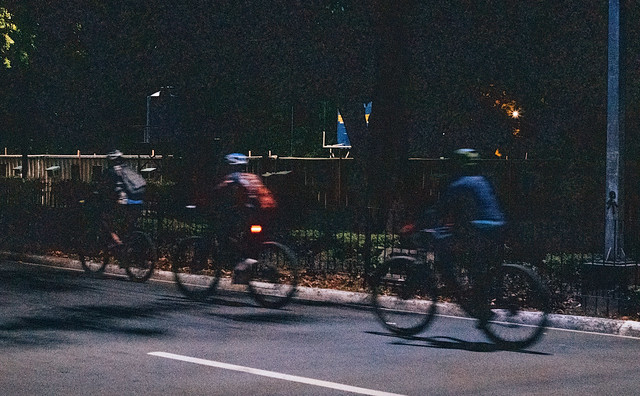 cyclists at night outside Harbour Square