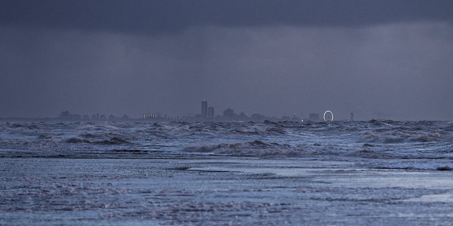 sea, storm, rain and a distant ferris wheel