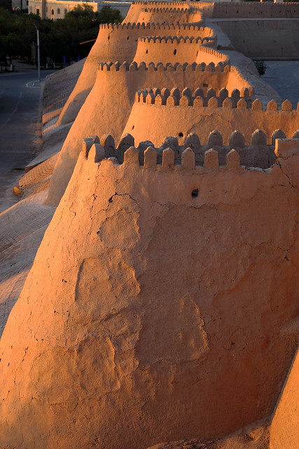 The crenellated brick walls of Khiva at sunset