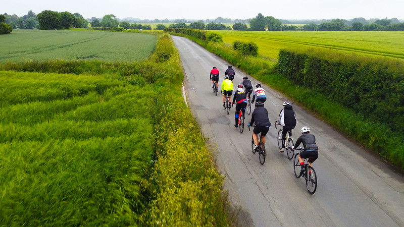 A group of cyclists riding on a country road.